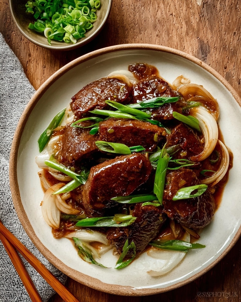 The dish shows about seven pieces of dark brown cooked meat with a shiny glaze on top, layered around the center of a white plate. Under and around the meat, there are cooked translucent white onion slices and bright green scallion pieces, adding contrast in color. The onions have a soft, slightly glossy look, and the scallions are fresh and crisp. The plate is set on a wooden surface with a small bowl of sliced green onions nearby, and a pair of chopsticks rests beside the plate. The overall look is warm and savory with a simple but appealing arrangement. photo taken with an iphone --ar 4:5 --v 7