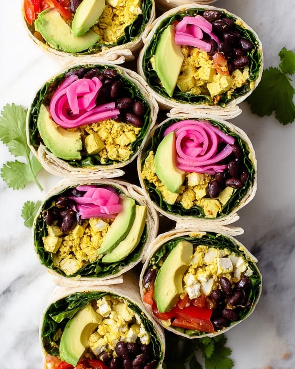 The image shows six cross-section views of wraps placed closely on a white marbled surface. Each wrap has multiple visible layers starting with a white tortilla on the outside followed by a layer of large dark green leafy greens. Inside, there is a layer of scrambled yellow tofu mixed with white tofu pieces, topped with light green avocado slices arranged side by side. Above the avocado, there are black beans clustered together and a swirl of bright pink pickled onions sits on top. Small bits of red bell pepper are also visible near the tofu layer, adding a splash of red. A few green cilantro leaves are scattered on the marbled background near the wraps. Photo taken with an iphone --ar 4:5 --v 7