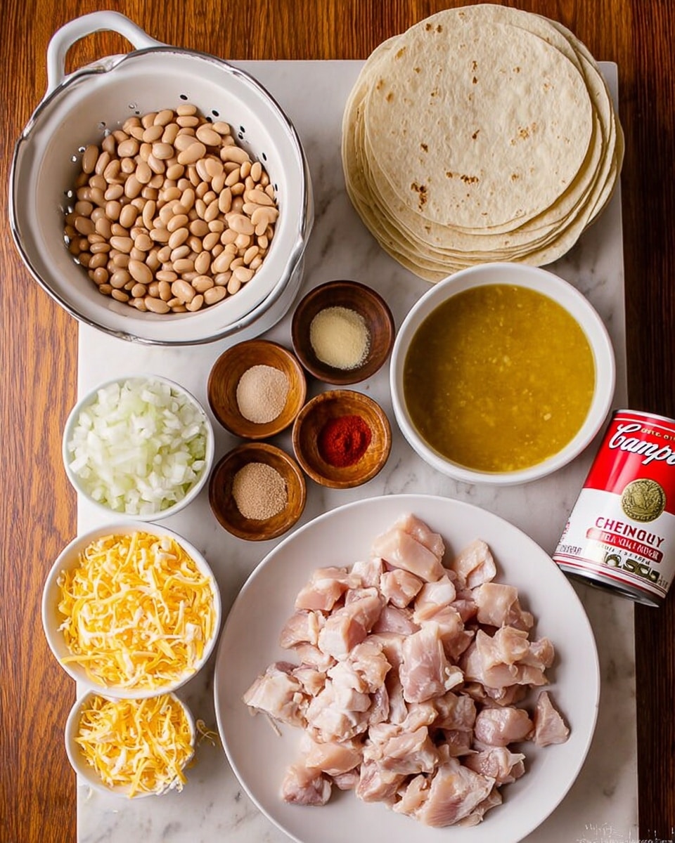 The image shows several ingredients arranged on a white marbled surface: a white colander filled with light brown beans at the top left, a stack of white tortillas to the top right, a white bowl with golden-yellow broth next to the tortillas, and a white bowl with shredded yellow and white cheese near the bottom left. There are three small wooden bowls in the middle with red, light brown, and beige spices. Below the spices is a large white plate filled with raw chopped chicken pieces. Nearby is a small white cup with chopped white onions and a red and white can of Campbell's cream of chicken soup. The wooden table underneath adds warmth to the scene. Photo taken with an iphone --ar 4:5 --v 7
