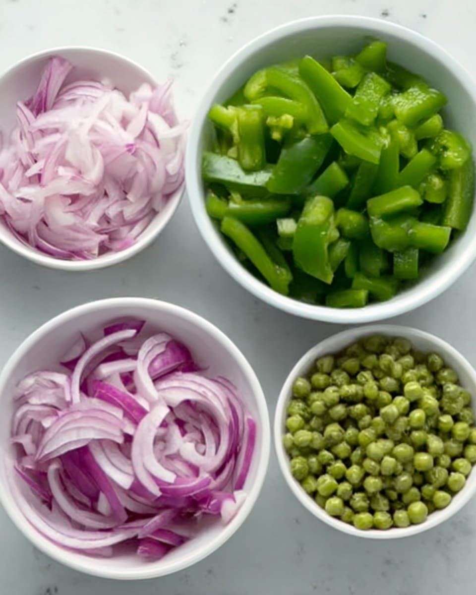 The image shows three small white bowls placed on a white marbled surface. The first bowl contains thinly sliced red onions with a slightly translucent texture and pale purple shade. The second bowl is filled with chopped green bell peppers that look fresh and vibrant, with a smooth, shiny texture. The third bowl has small green peas that appear cooked, with a soft matte finish. Each bowl is neatly arranged and evenly spaced. Photo taken with an iphone --ar 4:5 --v 7