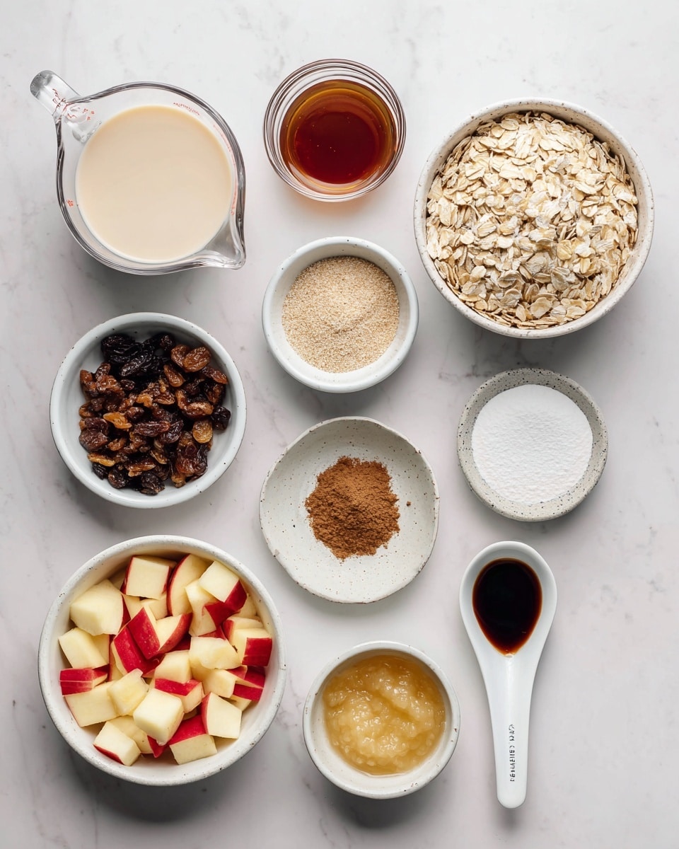 The image shows a top-down view of various cooking ingredients arranged neatly on a white marbled surface. There are ten containers: the largest bowl on the top right holds light brown rolled oats with a dry, flaky texture. To its left, a glass measuring cup contains smooth, creamy non-dairy milk. Below it, a small white pitcher is filled with dark amber maple syrup. In the center, a small white ramekin holds fine, ground flaxseed with a light beige tone. To the right of that, a shallow white dish has a mix of dark brown cinnamon powder and white sea salt side by side. Below it, a similar dish contains white baking powder. Near the bottom center, a small glass bowl has a pale yellow, slightly chunky applesauce. To its right, a small white ramekin contains clear, smooth coconut oil. At the bottom left, a white bowl is filled with small, colorful diced apples with red and white skin. Next to it, a white bowl contains wrinkled dark brown raisins. Above the bowls on the right, a white spoon-shaped dish has thick dark brown vanilla extract. The arrangement is clean, with all ingredients clearly visible for easy identification photo taken with an iphone --ar 4:5 --v 7