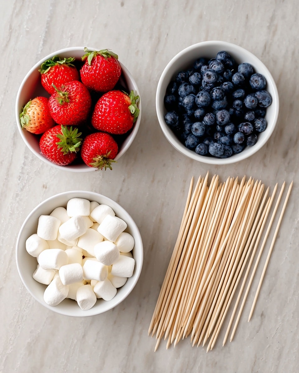 The image shows three white bowls and a group of wooden skewers on a white marbled surface. The first bowl, positioned on the left, is filled with bright red strawberries with green tops. The second bowl, placed at the top center, contains dark blue, round blueberries with a smooth texture. The third bowl, located at the bottom center, holds small, soft, white mini marshmallows. To the right of the bowls, there is a neat pile of light brown wooden skewers with pointed ends. Photo taken with an iphone --ar 4:5 --v 7