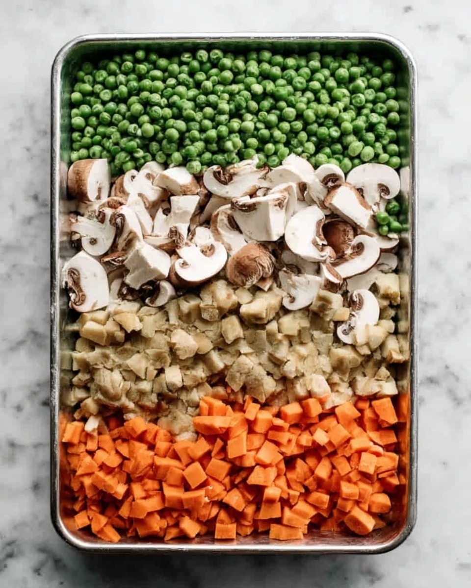 A metal tray with four layers of chopped vegetables arranged in neat rows. At the top is a thick layer of bright green peas, beneath them a layer of sliced white mushrooms with brown gills, followed by a cluster of smaller chopped mushrooms, and at the bottom, a layer of small orange carrot pieces. The tray is on a white marbled surface. Photo taken with an iphone --ar 4:5 --v 7
