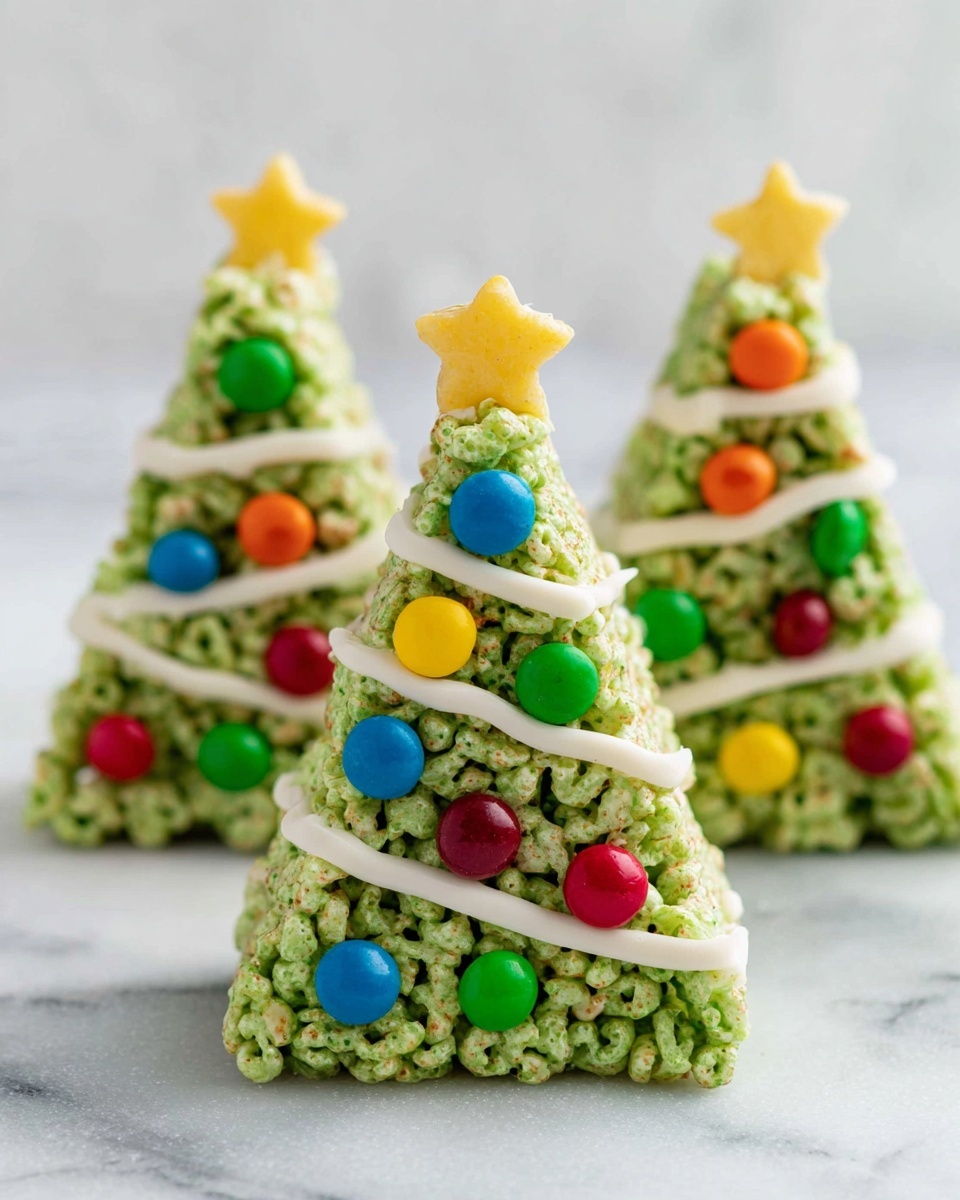 The image shows three Christmas tree-shaped treats made from green sticky cereal clusters, shaped into three small triangle layers with a rough texture. Each tree has a smooth white icing line zigzagging down from the top to bottom, resembling garland. Bright red, yellow, blue, green, and orange round candies are scattered on the surface of each tree, acting like colorful ornaments. At the top of each tree is a small flat yellow star candy. The treats stand on a white marbled surface with a soft, blurred white background. photo taken with an iphone --ar 4:5 --v 7
