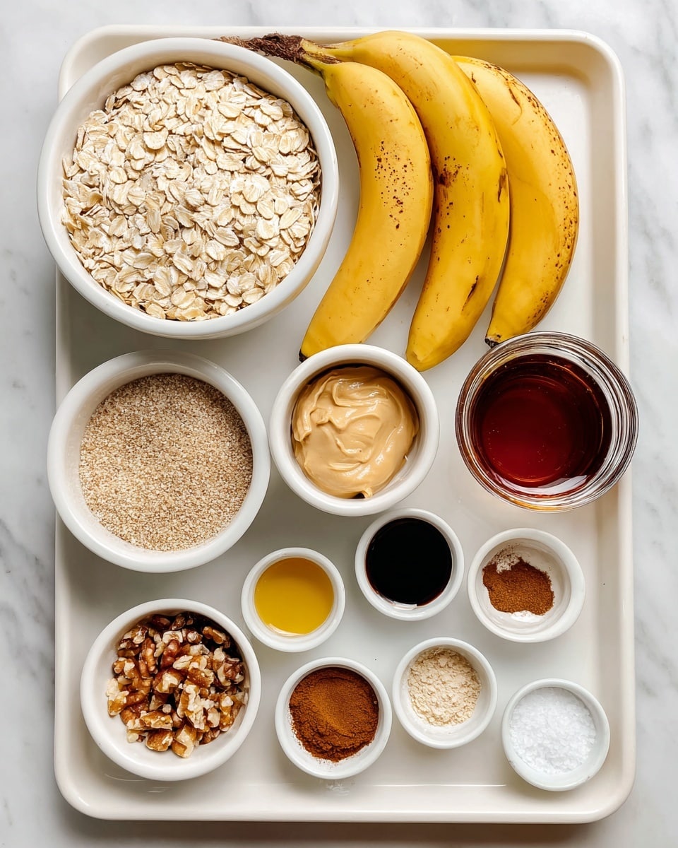 A top-down view of a baking tray on a white marbled surface holds several small white bowls and ingredients arranged neatly. The largest bowl on the left is filled with light beige oats, next to two ripe yellow bananas with brown spots. On the right side, a glass jar of dark maple syrup sits near a small clear bowl of creamy almond butter. Around these are smaller white bowls containing medium brown cinnamon powder, mixed chopped nuts, light brown soft brown sugar, golden melted butter or oil, white salt, and a small bowl with dark vanilla extract. Each item is spaced evenly on the tray, showing a clear and organized layout. photo taken with an iphone --ar 4:5 --v 7
