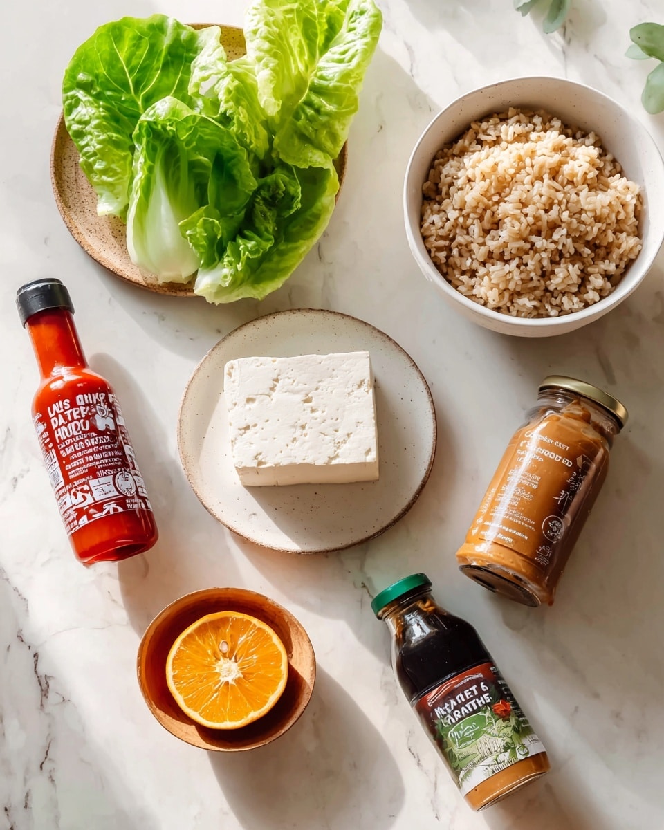 The image shows ingredients neatly placed on a white marbled surface. There is a block of tofu on a white plate, several bright green lettuce leaves nearby, a bowl filled with brown rice at the top right, a bottle of red sriracha sauce next to it, a bottle of dark brown teriyaki sauce below the sriracha, half an orange cut open showing its bright orange flesh, and a jar of peanut butter at the bottom. Each item is labeled with simple text. The setting is bright and clean with natural light. Photo taken with an iphone --ar 4:5 --v 7