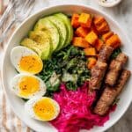 Savory Breakfast Bowl with Roasted Sweet Potatoes, Eggs, Sausage, and Sauerkraut Recipe