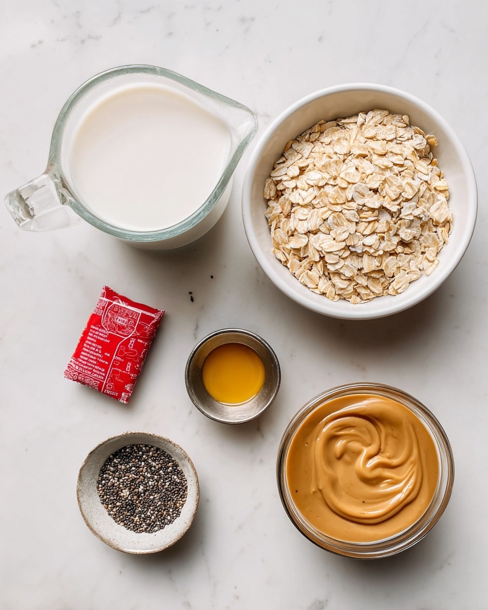 A clear glass measuring jug filled halfway with white dairy free milk is placed on the top left corner of a white marbled surface. To its right, a white bowl holds light brown dry oats with a slightly rough texture. Below the jug, a small red wrapped Lotus Biscoff biscuit lies flat. Near the biscuit, a small silver cup contains a bit of golden yellow vanilla extract. At the center bottom, a small metal bowl holds tiny, speckled black and white chia seeds. Finally, at the bottom right corner, a clear glass cup shows creamy, smooth, caramel-colored Lotus Biscoff spread. All items are spaced apart on the white marbled surface. photo taken with an iphone --ar 4:5 --v 7