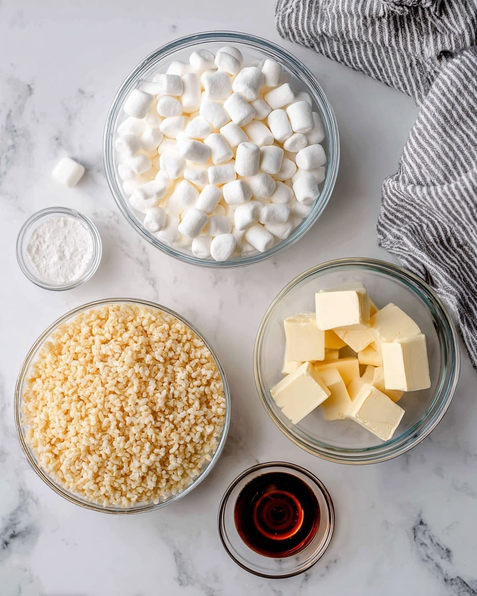 The image shows four clear glass bowls and a metal measuring cup arranged on a white marbled surface. The largest bowl at the bottom contains light golden rice krispies with a rough texture. Above it to the left is a medium large bowl filled with small white marshmallows that look soft and pillowy. To the right of the marshmallows is a metal measuring cup filled with similar small white marshmallows. Next to the cup, a smaller glass bowl holds several pale yellow cubes of butter with a smooth texture. Below that is a tiny glass cup with a small amount of dark amber vanilla extract. A striped gray and white towel is partially visible in the upper right corner. The items are spaced out neatly and labeled clearly with black uppercase text. photo taken with an iphone --ar 4:5 --v 7