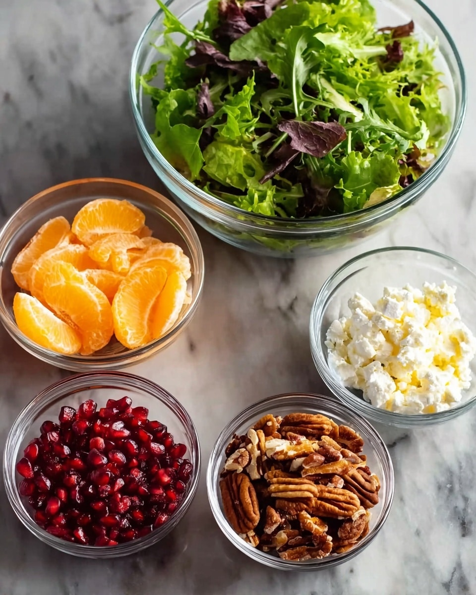 The image shows five clear glass bowls placed on a white marbled surface. The largest bowl at the back is filled with mixed green leafy lettuce, showing different shades of green and some purple leaves, with a fresh and crisp texture. In front of it, there are four smaller bowls. The top left bowl holds bright orange mandarin slices, shiny and plump. The top right bowl contains white crumbled cheese with a soft and crumbly texture. Below the mandarin slices, a bowl is filled with vibrant red pomegranate seeds that look juicy and glossy. The bottom right bowl has roughly chopped brown pecans with visible ridges and a crunchy texture. photo taken with an iphone --ar 4:5 --v 7
