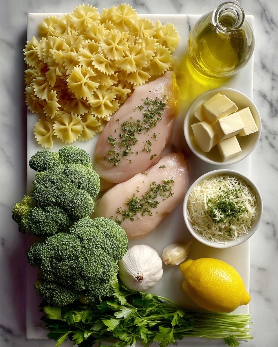 The image shows raw ingredients neatly arranged on a white marbled surface. There are two pale pink chicken breasts topped with small green herb pieces, placed near the center. To the left, a large bunch of fresh, dark green broccoli florets is shown. Above the chicken breast, there is a pile of uncooked yellow farfalle pasta. On the right side, two small white bowls are filled with shredded cheese — one topped with two slices of butter, the other mixed with herbs. Between the chicken and the bowls is a garlic clove. Below the chicken, a half lemon is placed with the cut side facing up, and next to it is a whole bulb of garlic. At the top center, there is a clear bottle of light yellow olive oil. Photo taken with an iphone --ar 4:5 --v 7