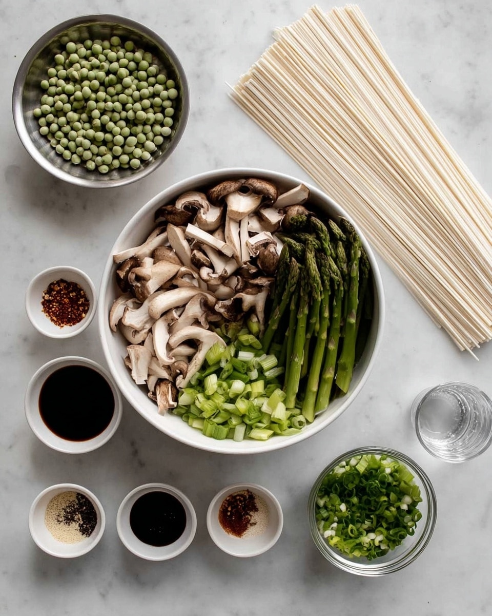 A white bowl filled with two sections: sliced light brown mushrooms with a soft texture on the left side, and chopped green asparagus pieces on the right side. To the bottom left, a round silver container holds many small, round green peas. Next to the mushroom and asparagus bowl, there are long, flat, uncooked white noodles laid out in a neat stack. In the top right corner, a small white bowl contains chopped green onions with different green shades. Around this, four small white bowls hold, from top left going clockwise, dark soy sauce, a mix of finely minced garlic and ginger, some ground spices in red, black, and white, and white sesame seeds. A clear glass bowl with water is near the bottom edge. All ingredients are arranged on a white marbled surface. photo taken with an iphone --ar 4:5 --v 7
