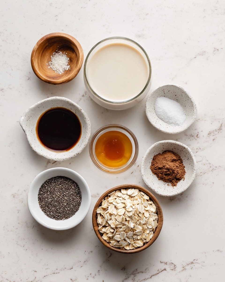 The image shows several ingredients placed on a white marbled surface, each in clear bowls or containers arranged in rows. On the top row from left to right are three clear bowls filled with white flour, white granulated sugar, and white powdered sugar. Below these, there is a small clear cup with dark brown vanilla extract on the left, a jar of instant espresso with a green lid in the center, and a round metal cup with light brown condensed milk on the right. Below these are a small white bowl with white cornstarch, a small gray bowl with white salt, and two sticks of pale yellow unsalted butter side by side on the right. Each ingredient is labeled in simple black text on soft pink labels placed above or next to them. The overall look is neat and well-organized with a clean, bright, and minimal style. Photo taken with an iphone --ar 4:5 --v 7