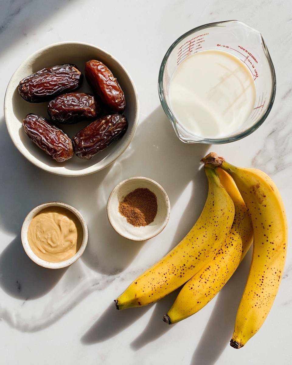 The image shows a white marbled surface with six different items arranged neatly. On the top left, there is a small white bowl filled with four large dark brown dates with a wrinkled texture. Below it, a clear glass measuring cup contains white milk, showing the liquid level clearly. In the middle right, there are two long yellow bananas with brown spots lying next to each other. Between the bananas and the dates, there is a small white ceramic bowl filled with a tan, creamy smooth paste. Below that bowl, a tiny white bowl holds a small amount of brown ground cinnamon. The light casts soft shadows around the items, creating a clean and fresh look. photo taken with an iphone --ar 4:5 --v 7