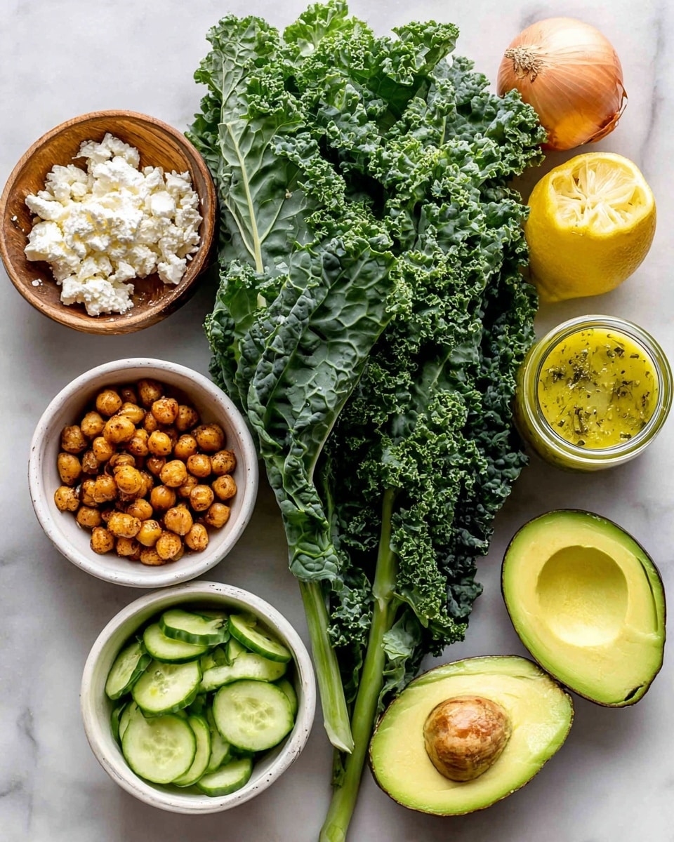 The image shows fresh ingredients arranged on a white marbled surface. At the center is a large bunch of curly dark green kale with thick stems. To the top left, there is a small wooden bowl filled with white, crumbly feta cheese. To the top right of the kale is a whole shallot with a smooth light brown skin. Beside the shallot, there is a small glass jar containing a yellow dressing with visible herbs. Below the dressing is a white bowl filled with thin pale green cucumber slices. To the bottom left of the kale, there is a white bowl holding small, crispy roasted chickpeas in a golden brown color. Next to the chickpeas are two halves of a fresh avocado with smooth green flesh and a brown seed in one half. At the bottom right of the image is half a lemon with bright yellow skin and juicy segments visible. Photo taken with an iphone --ar 4:5 --v 7