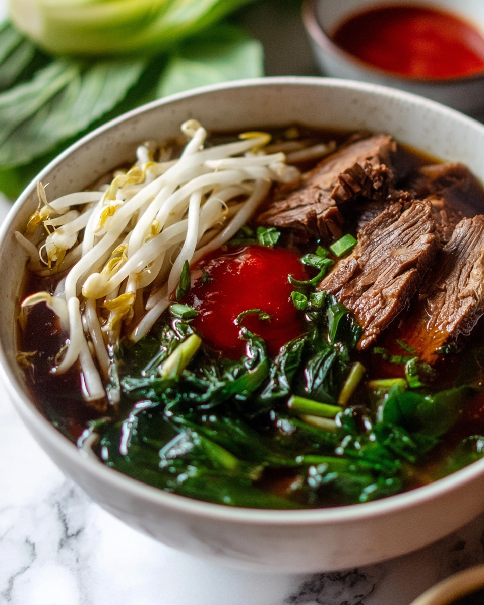A close-up of a white bowl shows a rich, dark broth filled with bright green leafy vegetables at the bottom layer. On one side, there are fresh white bean sprouts with a crisp texture, partially sitting in the broth. On the top right, thick slices of brown, cooked meat with visible texture lines rest on the greens. In the middle, a dollop of bright red sauce adds a strong color contrast. Small green chopped herbs are scattered around the broth, creating a fresh touch. The bowl is placed on a white marbled surface, with parts of green leafy vegetables and a bowl of red sauce blurred in the background, photo taken with an iphone --ar 4:5 --v 7