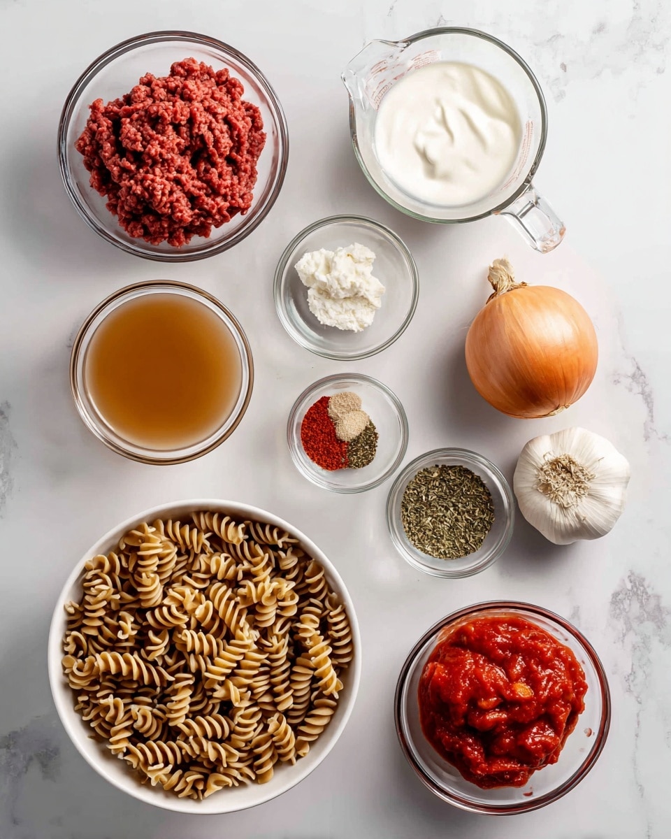 The image shows a white marbled surface with clear glass bowls and a white bowl holding cooking ingredients arranged neatly. The white bowl at the bottom left is filled with uncooked brown spiral pasta. Above it to the left, a small clear glass bowl holds raw red beef. To the right of the beef, a clear glass measuring cup contains white cream, and below it, another clear glass measuring cup has light brown chicken broth. On the right side, there is a light brown whole onion, two garlic cloves, a small white bowl with red pepper flakes, another small white bowl with green Italian herbs, a small clear glass bowl filled with red tomato paste, and a larger clear glass bowl with bright red crushed tomatoes. The ingredients are evenly spaced and well lit, photo taken with an iphone --ar 4:5 --v 7